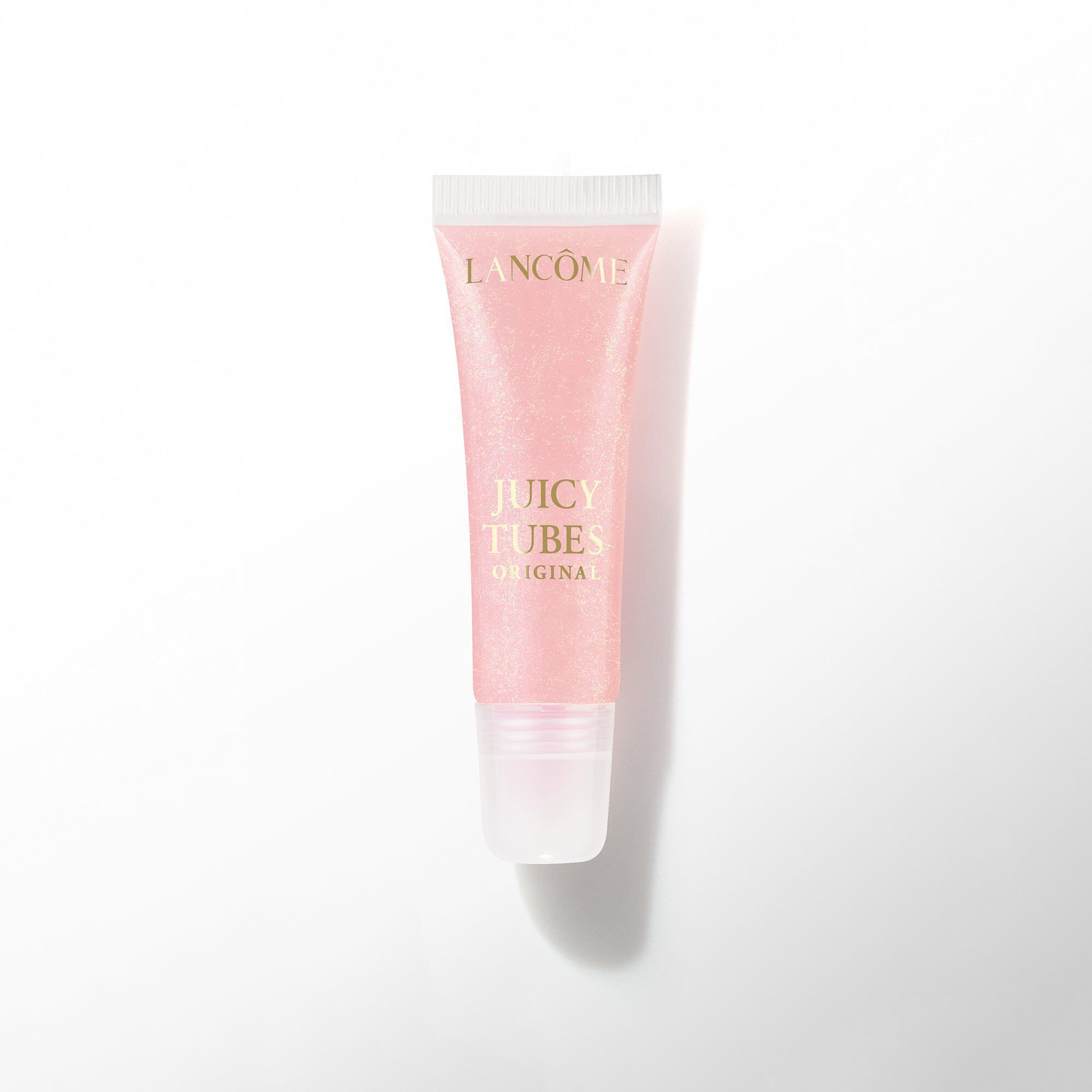 Un tubo de brillo de labios Lancome Juicy Tubes Original en un tono rosa palido claro.