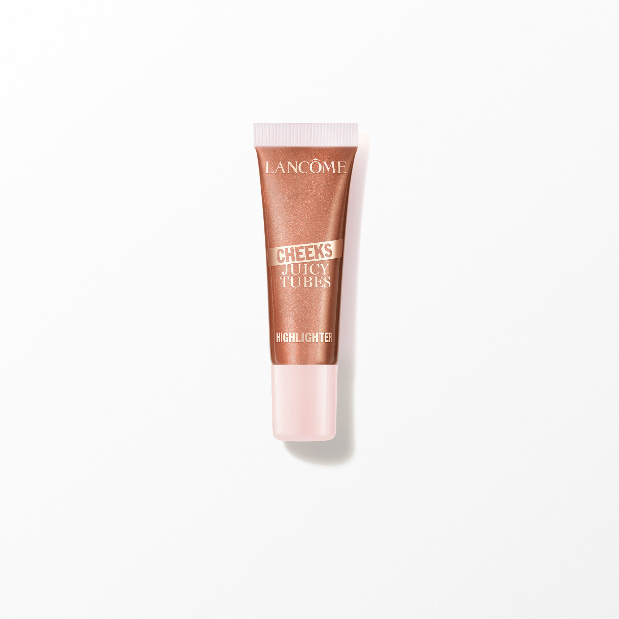 Tubo de iluminador de mejillas de tubos jugosos de Lancome sobre blanco.
