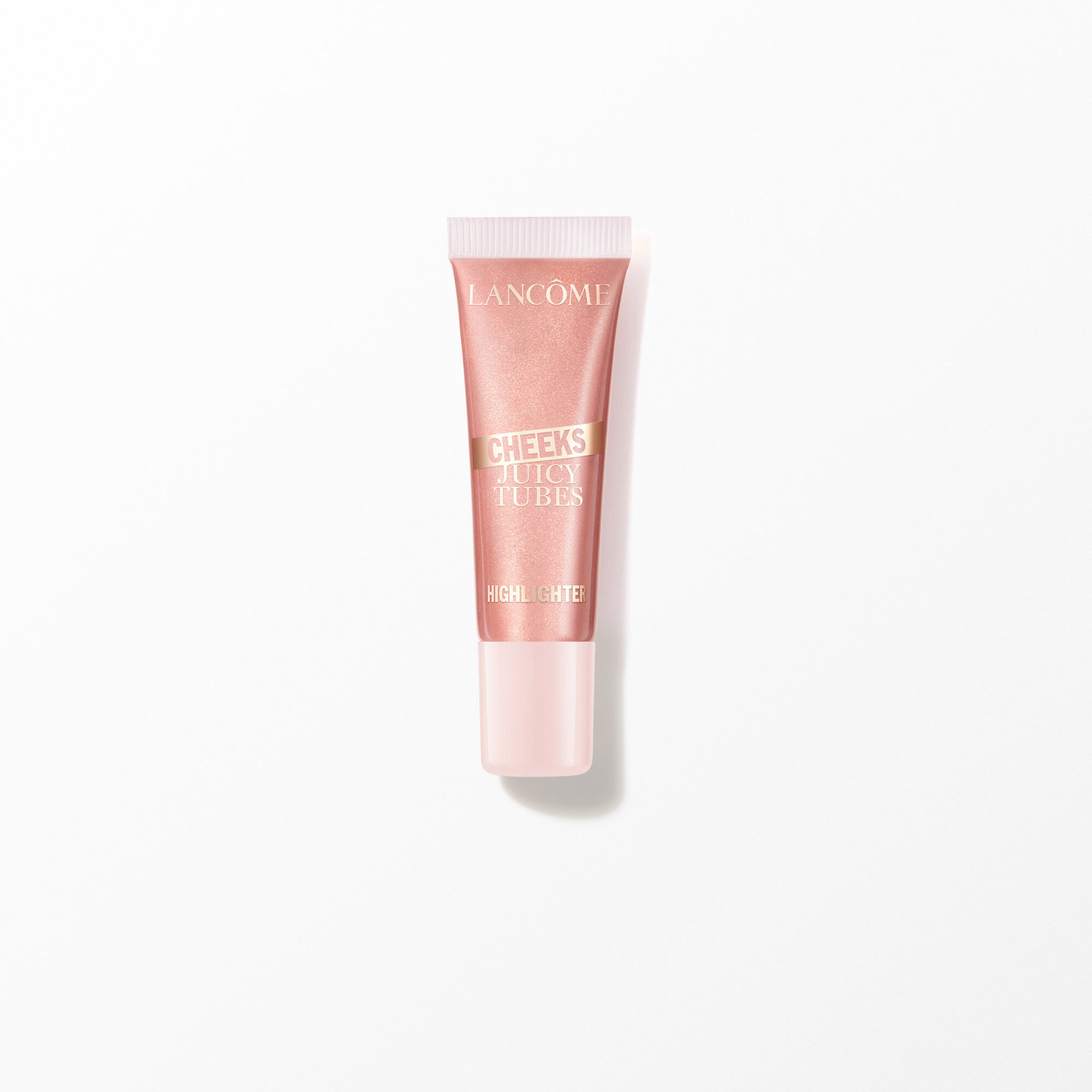Tubo de iluminador de mejillas de tubos jugosos de Lancome sobre blanco.