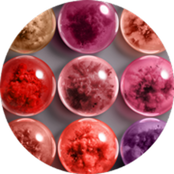 Conjunto de esferas de colores vibrantes en tonos rosa, rojo y morado, sobre un fondo gris.