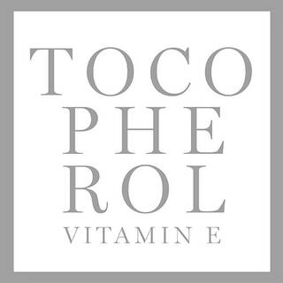 Texto en un fondo blanco que dice "TOCOPHEROL" en letras grandes y "VITAMINA E" debajo, en letras mas pequenas.
