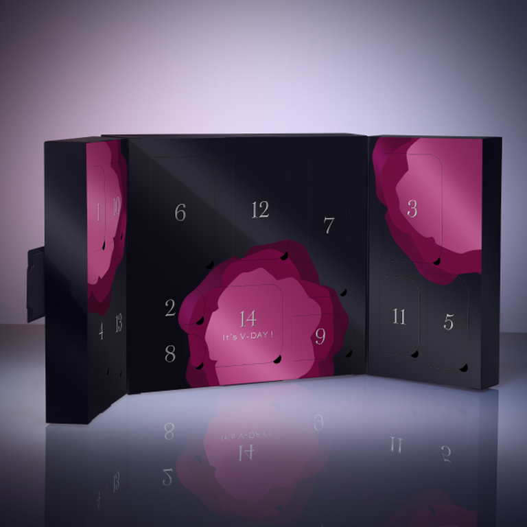 Un calendario de adviento en tonos negros y rosas, con casillas numeradas y un diseno floral, anunciando el Dia de San Valentin.